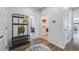 Open hallway features wood floors, hall tree, and a view to the laundry room and living spaces at 8517 Eckley St, Littleton, CO 80125