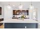 Stylish kitchen features a large island with pendant lighting and stainless steel appliances at 8517 Eckley St, Littleton, CO 80125