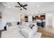 Bright, open-concept living space flows from living room to kitchen with island and pendant lights at 8517 Eckley St, Littleton, CO 80125