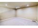 Spacious finished basement area with neutral walls and carpet at 9585 Pearl Cir # 203, Parker, CO 80134