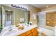 Bright bathroom features double sinks, vanity, and a shower with glass doors at 9585 Pearl Cir # 203, Parker, CO 80134