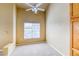 The bright bedroom includes a ceiling fan and a large window at 9585 Pearl Cir # 203, Parker, CO 80134