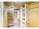 Walk-in closet features custom shelving and ample storage space at 9585 Pearl Cir # 203, Parker, CO 80134