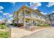Exterior shot of a yellow townhome featuring a covered porch at 9585 Pearl Cir # 203, Parker, CO 80134