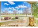 View of neighborhood from cozy front porch with stone supports and landscaping at 9585 Pearl Cir # 203, Parker, CO 80134