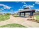 Community gazebo with seating, lawn, and walking path at 9585 Pearl Cir # 203, Parker, CO 80134