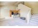 Bright open-concept room with vaulted ceilings, stairs, and kitchen with a breakfast bar at 9585 Pearl Cir # 203, Parker, CO 80134