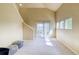 A well-lit living room with tall ceilings, access to the outdoor patio, and natural light at 9585 Pearl Cir # 203, Parker, CO 80134