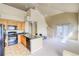 Open concept kitchen and living space with a staircase leading to the second level at 9585 Pearl Cir # 203, Parker, CO 80134