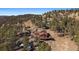 Stunning exterior view of a brown home featuring a deck, large windows, and beautiful natural surroundings at 24847 Richmond Hill Rd, Conifer, CO 80433