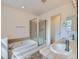 Bathroom featuring a tiled tub and a vanity with double sinks at 5155 W Quincy Ave # J103, Denver, CO 80236