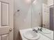 Tiled bathroom vanity featuring a large mirror and chrome fixtures at 5155 W Quincy Ave # J103, Denver, CO 80236