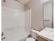 Bathroom features a tub/shower combo, and a white ceramic toilet and sink at 5155 W Quincy Ave # J103, Denver, CO 80236