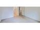 Neutral carpeted room showcasing an open doorway, white trim and baseboards at 5155 W Quincy Ave # J103, Denver, CO 80236