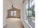 Spacious bedroom with a vaulted ceiling, neutral carpet, and large windows offering an abundance of natural light at 5155 W Quincy Ave # J103, Denver, CO 80236