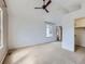 A bright, carpeted bedroom with a ceiling fan and a walk-in closet at 5155 W Quincy Ave # J103, Denver, CO 80236