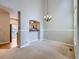 Elegant dining area with a chandelier, offering a seamless flow to the kitchen at 5155 W Quincy Ave # J103, Denver, CO 80236