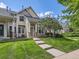 Charming townhouse with well-maintained lawn, front steps, and inviting facade surrounded by lush greenery at 5155 W Quincy Ave # J103, Denver, CO 80236