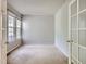 Bright living room with carpet, a large window and glass paneled doors at 5155 W Quincy Ave # J103, Denver, CO 80236