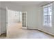 Bright living room with beige carpet and white trim showcasing an open doorway and natural light at 5155 W Quincy Ave # J103, Denver, CO 80236