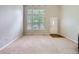 Bright living room featuring tall windows, neutral paint, and carpeted floors at 5155 W Quincy Ave # J103, Denver, CO 80236