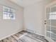 Bright room with stylish floors showing the transition to a private outdoor patio through glass doors at 5155 W Quincy Ave # J103, Denver, CO 80236