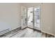 Bright room with stylish floors, showing the transition to a private outdoor patio through glass doors at 5155 W Quincy Ave # J103, Denver, CO 80236