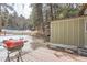 Backyard featuring a deck, grill and a wooded area with snow at 30690 Highway 72, Golden, CO 80403