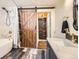 Bathroom featuring a sliding barn door, shower and soaking tub at 30690 Highway 72, Golden, CO 80403