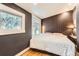 Bedroom featuring a white bed, patterned wallpaper, hardwood floors and natural light at 30690 Highway 72, Golden, CO 80403