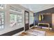 Inviting entry room with hardwood floors, large windows, and rustic accents at 30690 Highway 72, Golden, CO 80403