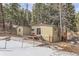 Exterior view of the home, featuring a deck, patio and wooded lot at 30690 Highway 72, Golden, CO 80403