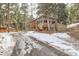 Charming wooded home with a porch, large windows, and a tranquil drive-up appeal at 30690 Highway 72, Golden, CO 80403