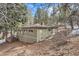 Charming single-Gathering home nestled among the trees featuring durable siding and a classic roof at 30690 Highway 72, Golden, CO 80403