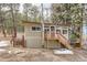 Charming home featuring a wooden porch, large windows, and lush surroundings at 30690 Highway 72, Golden, CO 80403