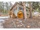 Charming home featuring a wooden porch, large windows, and lush surroundings at 30690 Highway 72, Golden, CO 80403