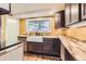 Kitchen featuring wooden cabinets and a farmhouse sink at 30690 Highway 72, Golden, CO 80403