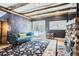 Cozy living room featuring a stone fireplace and wood beam ceilings at 30690 Highway 72, Golden, CO 80403