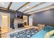 Inviting living room featuring stone fireplace and wood beam ceilings at 30690 Highway 72, Golden, CO 80403