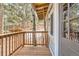 View of the wood porch overlooking the trees and surroundings at 30690 Highway 72, Golden, CO 80403
