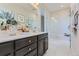 Luxurious bathroom with glass walk-in shower, dark wood vanity with white countertops, and modern fixtures at 14127 Deertrack Ln, Parker, CO 80134