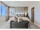 Comfortable main bedroom featuring stylish wall decor, seating area, and ample natural light at 14127 Deertrack Ln, Parker, CO 80134