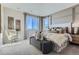 Serene main bedroom features large windows, decorative wall paneling, and a comfortable seating area at 14127 Deertrack Ln, Parker, CO 80134