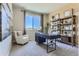 Cozy office space featuring a large window, comfortable seating, desk, and stylish shelving unit at 14127 Deertrack Ln, Parker, CO 80134