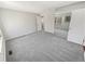 Bright bedroom with grey carpet and mirrored closet doors at 2354 S Troy St, Aurora, CO 80014