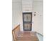 Front entrance to a townhouse with a security door and wooden walkway at 2354 S Troy St, Aurora, CO 80014