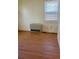 Bedroom with hardwood floors and radiator under the window at 914 La Farge Ave, Louisville, CO 80027
