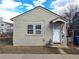 Exterior view of a cozy home featuring neutral siding, a covered entry, and classic architectural details at 914 La Farge Ave, Louisville, CO 80027