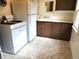 Quaint kitchen featuring white appliances, vintage sink and dark cabinets at 914 La Farge Ave, Louisville, CO 80027