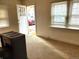 Sunlit living room featuring carpet and a view of the front entryway with a red car parked in front at 914 La Farge Ave, Louisville, CO 80027